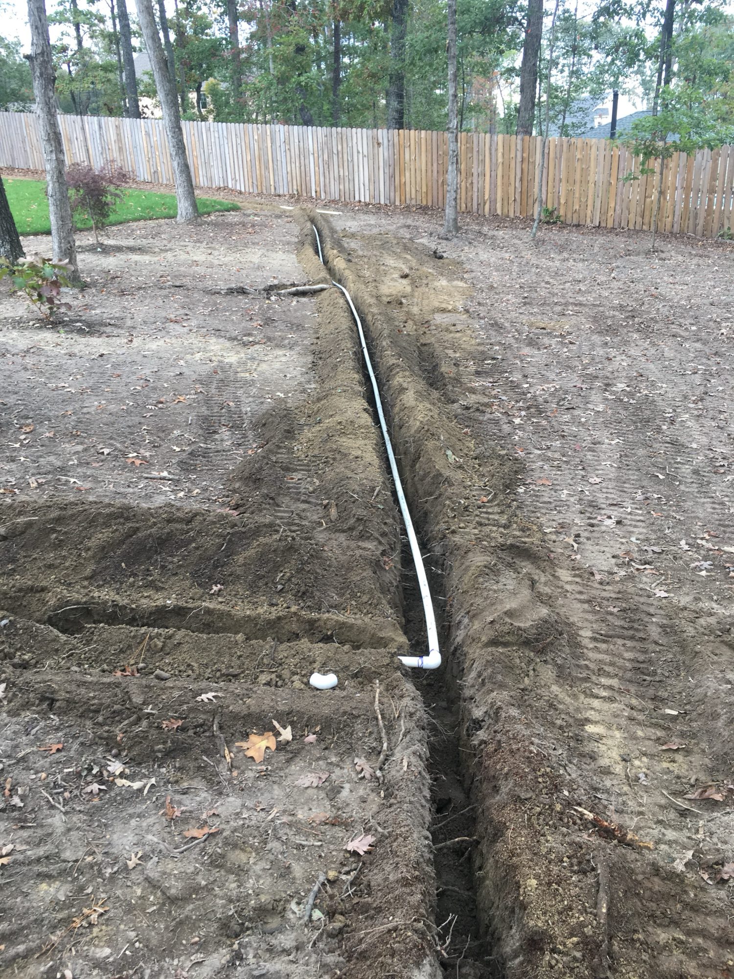 Trenched irrigation line in dark soil