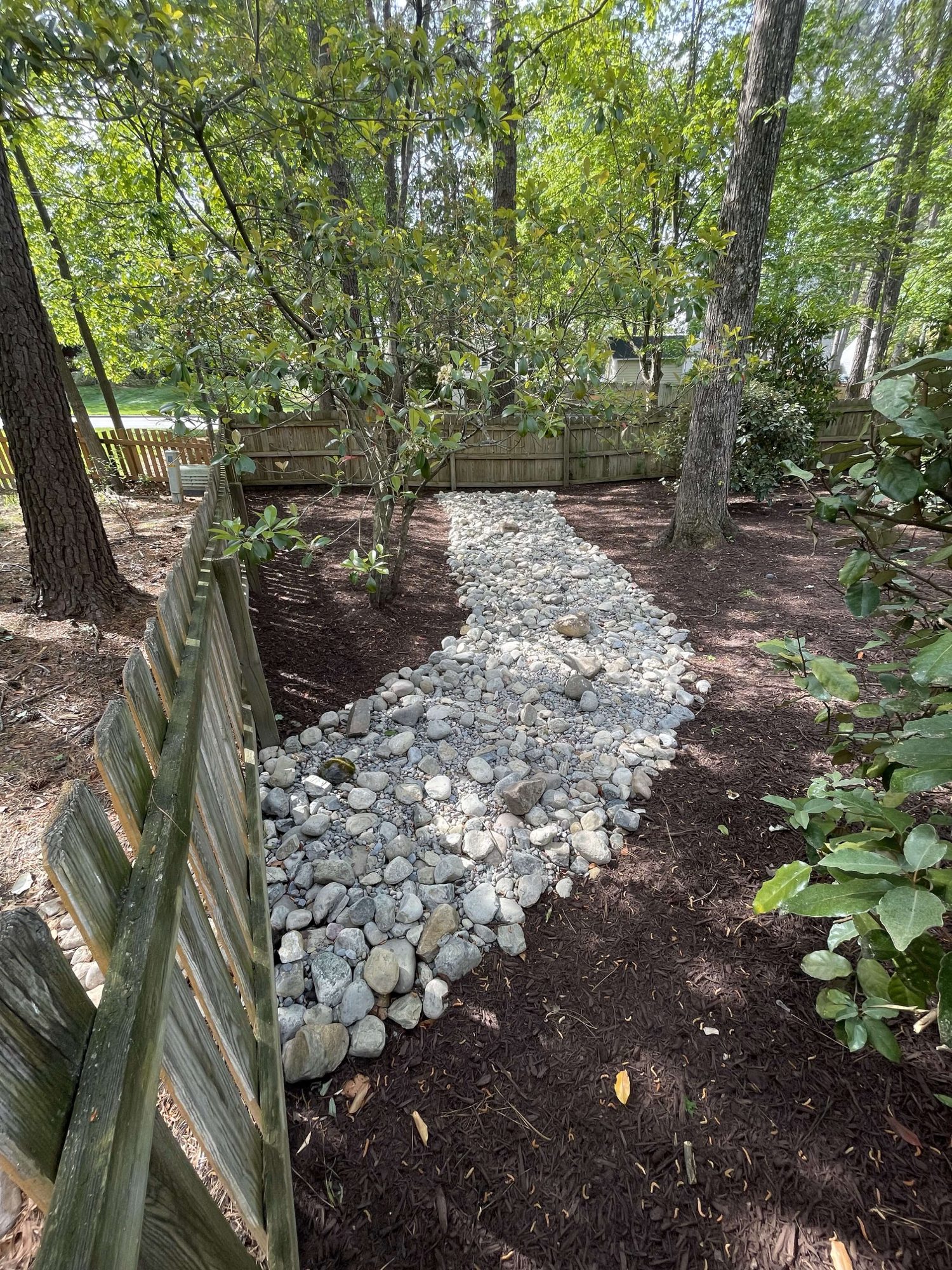 Dry creek bed installed in back yard to aid in drainage