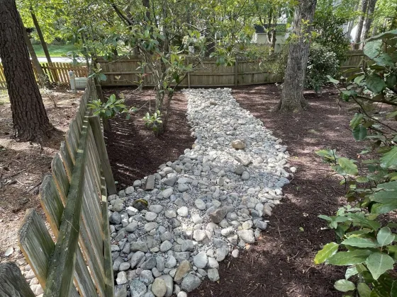 Dry creek bed installed in back yard to aid in drainage