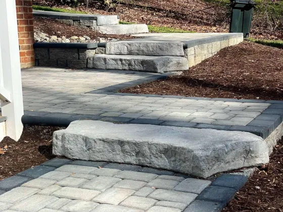 Paver walkway and stone steps leading up