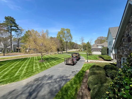 Our truck and trailer in driveway with freshly striped yard and trimmed bushes