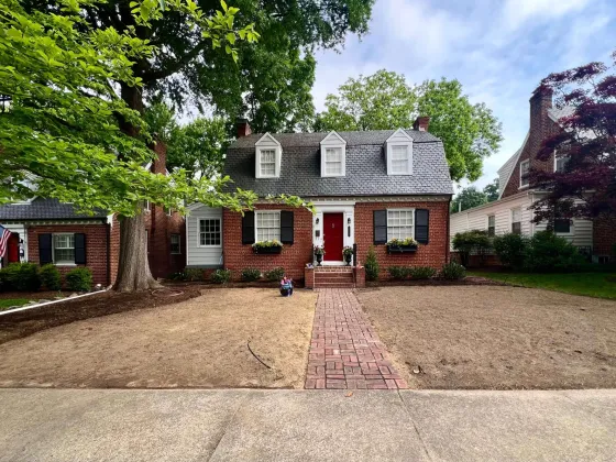 Yard with new irrigation system, landscape lighting, freshly installed walkway, and prepped for sod